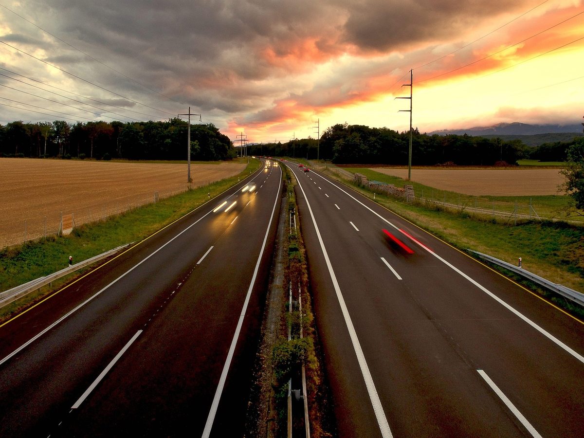 Cars on a highway at sunset (Florida auto insurance)