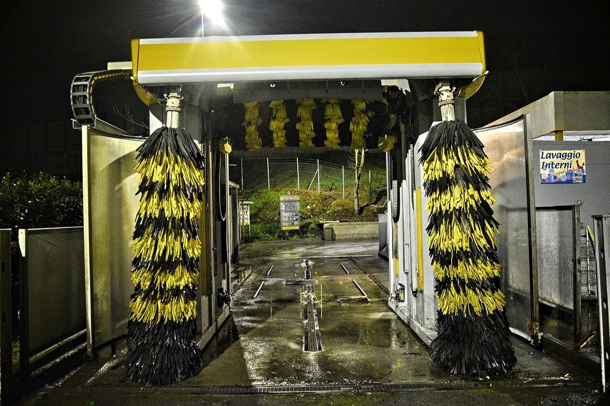 Automatic car wash bay with rotating brushes (Florida car wash insurance)