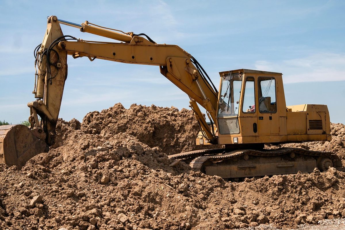 Excavator digging at a construction site (Florida excavator insurance)