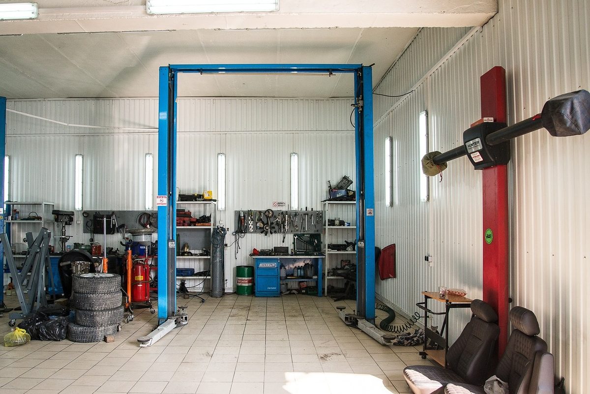 Auto repair garage bay with a two-post vehicle lift (Florida garage liability insurance)