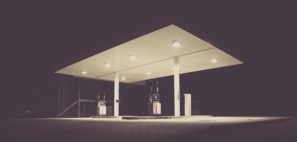 Gas station canopy and fuel pumps at night (Florida gas station insurance)