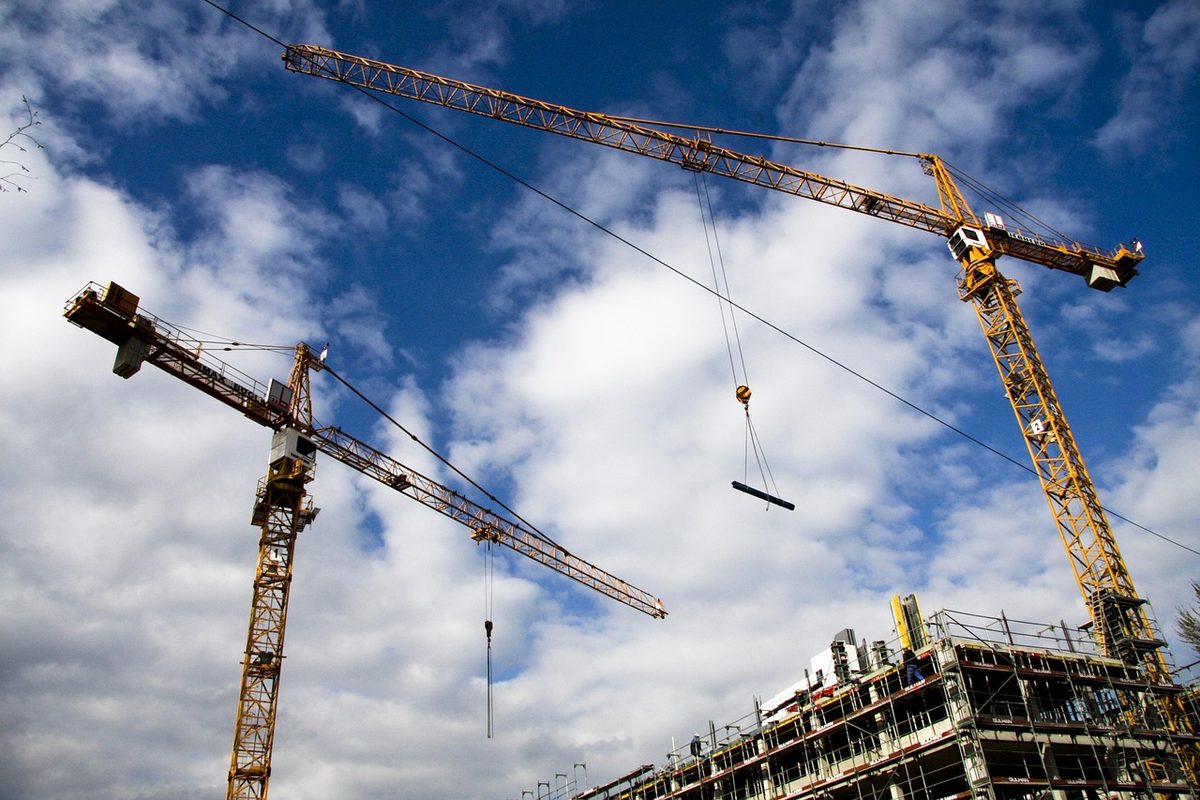 Tower cranes over a building under construction (Florida general contractor insurance)