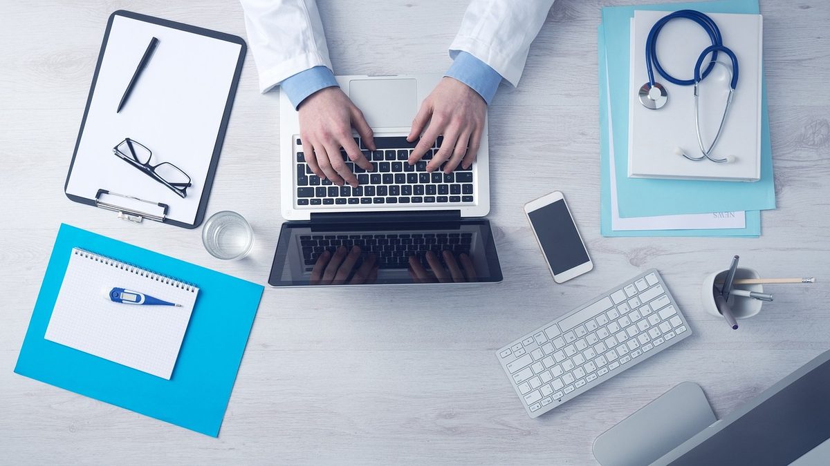 Doctor's desk with a stethoscope, laptop and clipboard (Florida medical office insurance)